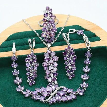 Vintage jewellery set with floral patterns showing necklace, bracelet, earrings and ring in olive green colour