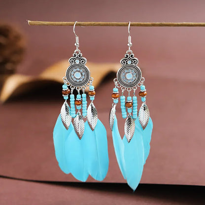 Round drop feather earrings in a bohemian leaf shape with patterned detail, shown in a light pink electroplated colour.