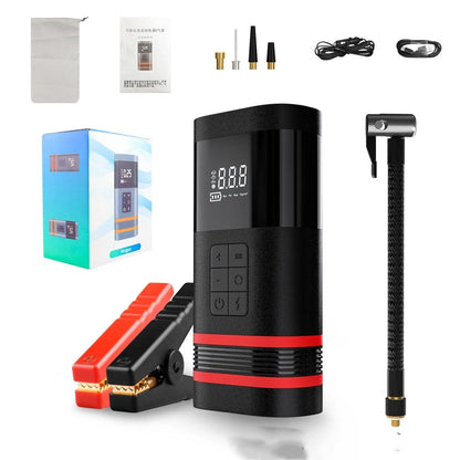 Black wireless portable 100W car jump starter power bank with jumper pins and charging cables on a table.
