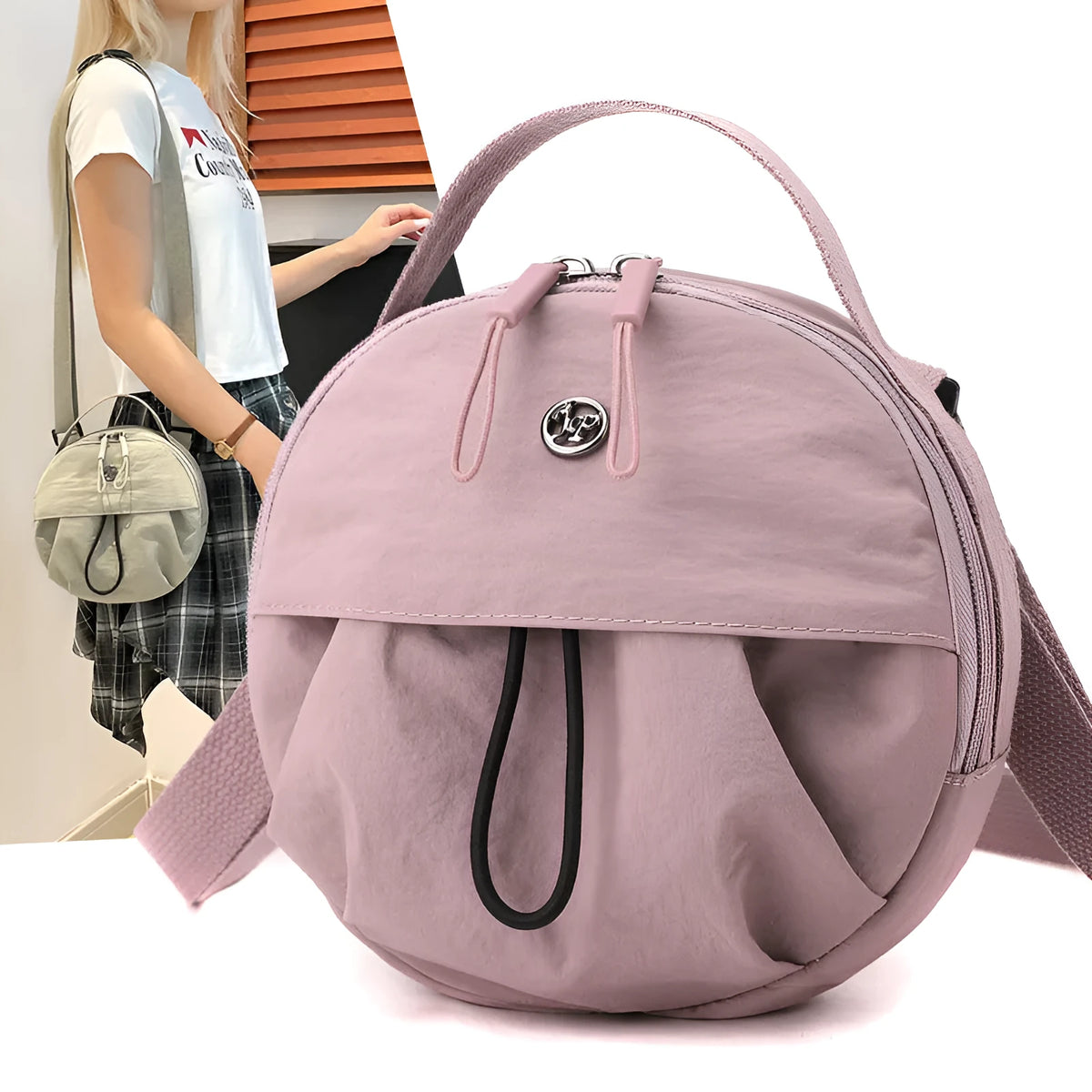 Out shoulder crossbody messenger bag in nylon showing interior zipped changing bag, phone pocket, and document compartment.