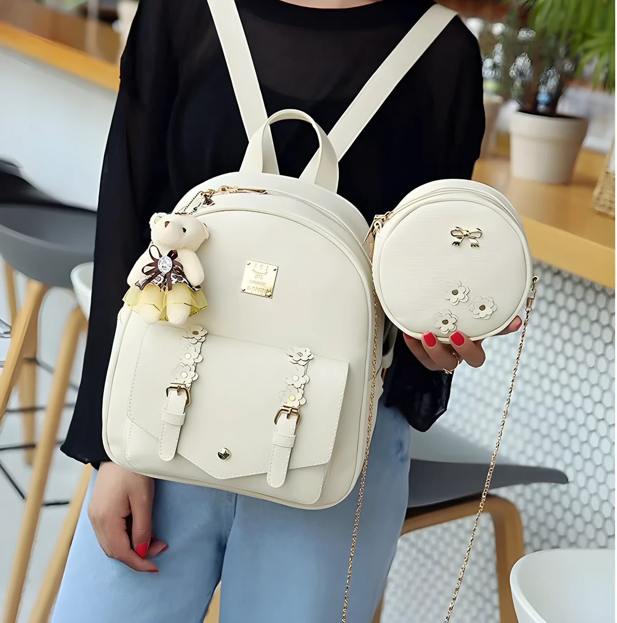Women's black PU leather backpack, shoulder bag, and card bag set with flower designs.