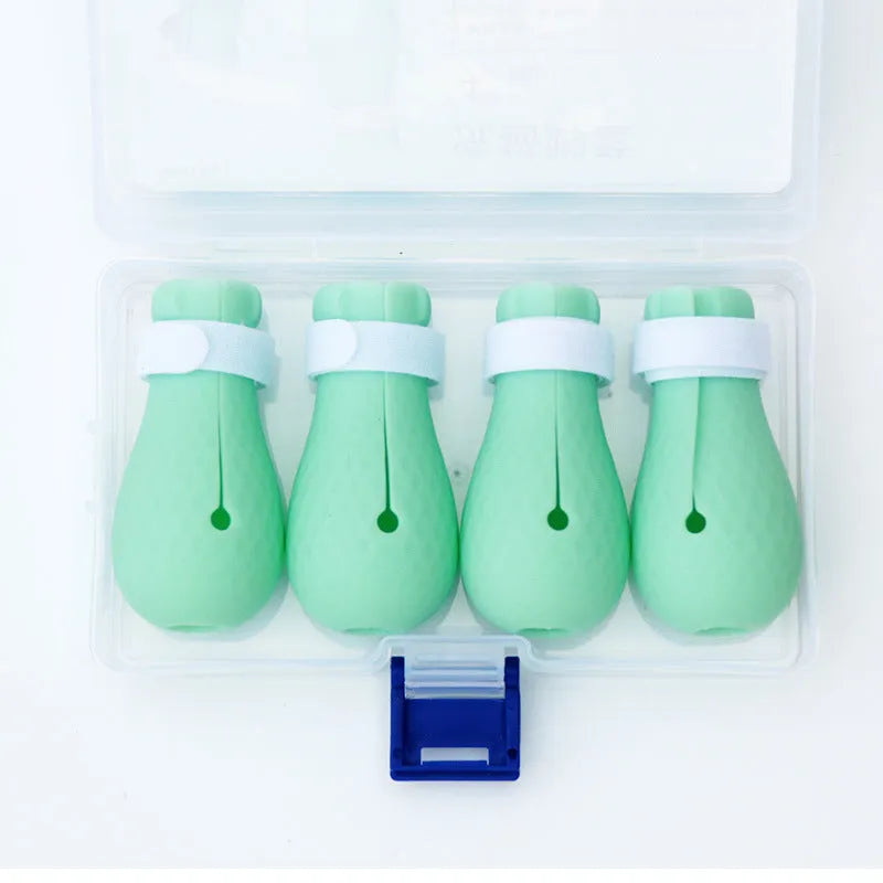 Four green silicone cat paw scratch protector foot covers for pet grooming and handling