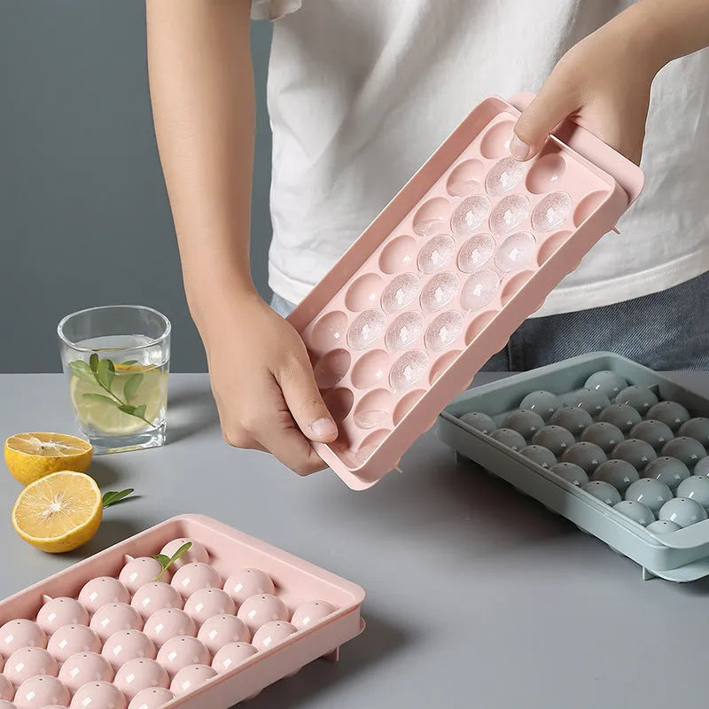 Sky blue and pink 3D round ice moulds creating spherical ice balls for drinks