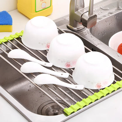 Stainless steel sink drain rack with rolling curtain design folded to show compact 5cm storage thickness
