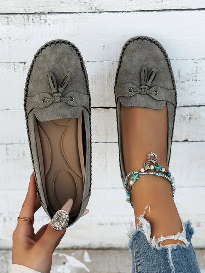 Women's solid-colour suede flat shoes with a bow on the front, shown in apricot colour.