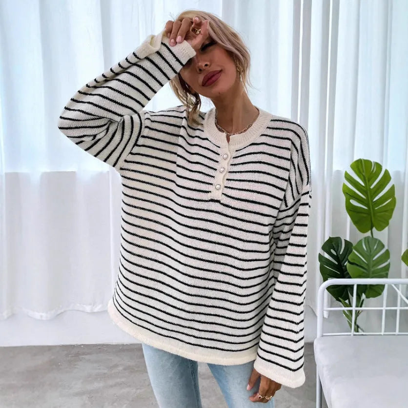 Black and white striped women's casual top with drop-shoulder sleeves and button detail