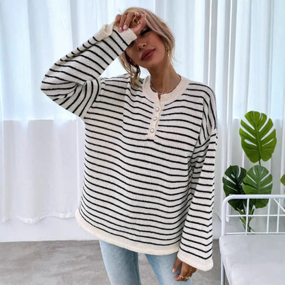 Black and white striped women's casual top with drop-shoulder sleeves and button detail