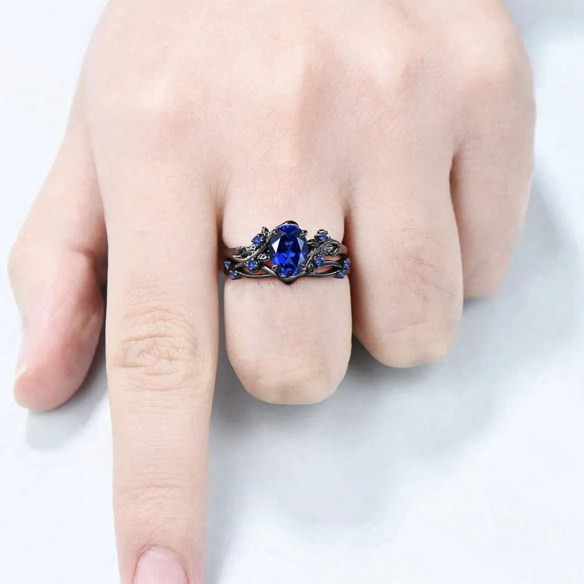Geometric black women's couple ring with navy blue rhinestone inlay showing side profile