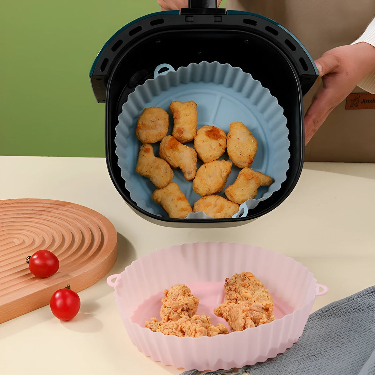 Round blue silicone baking tray mat with 4.5cm sides on a kitchen counter.