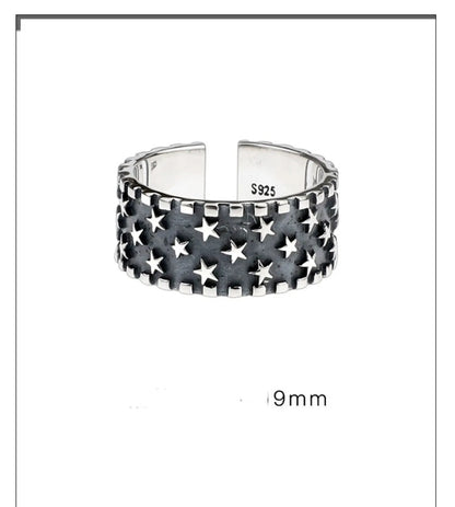 Adjustable opening sterling silver ring with etched five-pointed star geometry pattern on a band.