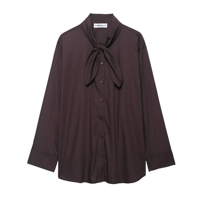 Brown women's loose-fit poplin shirt with long sleeves and an attached bow tie scarf.