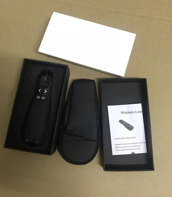 Black wireless presentation remote pen with laser pointer and stored USB receiver.