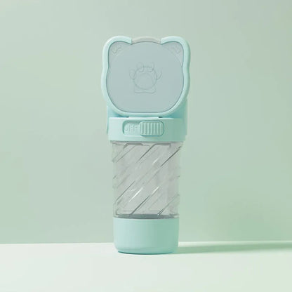 Green 3-in-1 pet water bottle with strap, showing water dispenser, food container, and waste bag dispenser for outdoor use