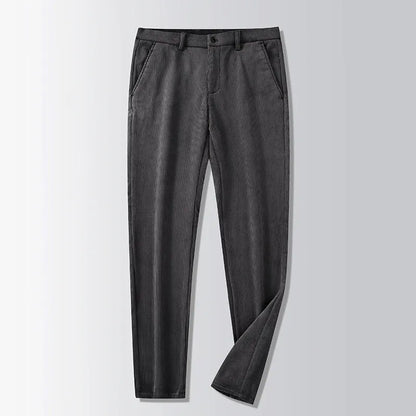 Man wearing khaki and black striped straight-leg retro trousers with a zip fly.