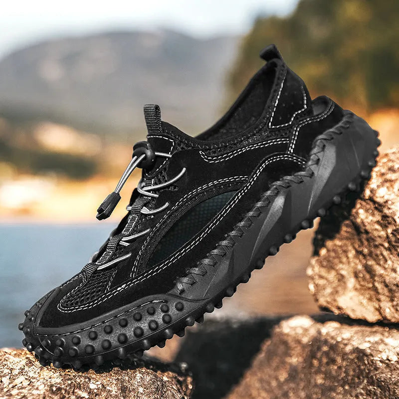 Men's black waterproof wading sandals with elastic band and perforated leather mesh upper on a rubber sole.