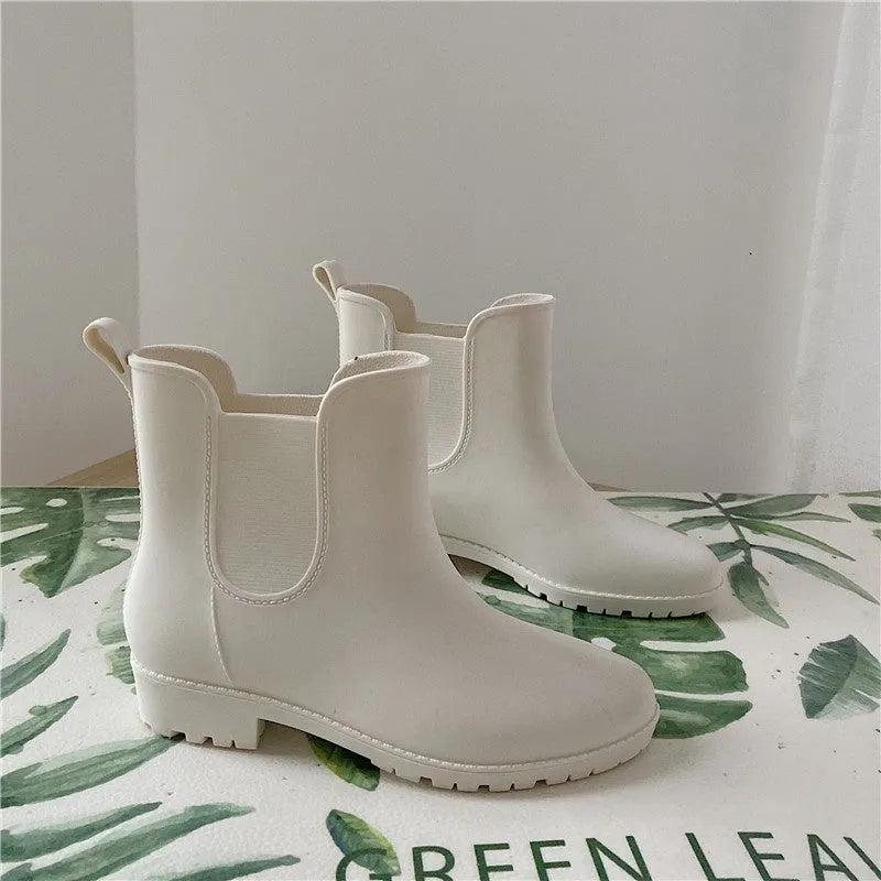 Pair of short casual PVC rain boots with non-slip sole and 3-5cm mid heel, shown in pink, milky white, and black