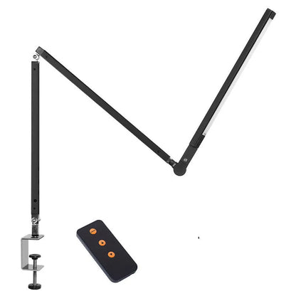 Adjustable aluminium desk lamp with remote control, shown in black with a clip attached to a desk edge.