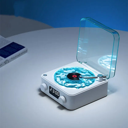 Retro-style turntable Bluetooth speaker with glowing RGB light projection on a wooden surface.
