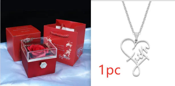 Rotating rose jewellery gift box with a preserved red rose under a clear acrylic dome, showing the interior rotating drawer.