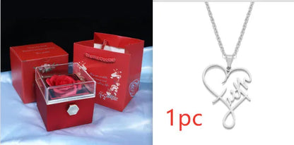 Rotating rose jewellery gift box with a preserved red rose under a clear acrylic dome, showing the interior rotating drawer.