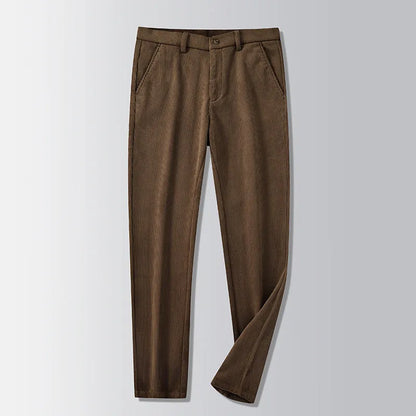 Man wearing khaki and black striped straight-leg retro trousers with a zip fly.