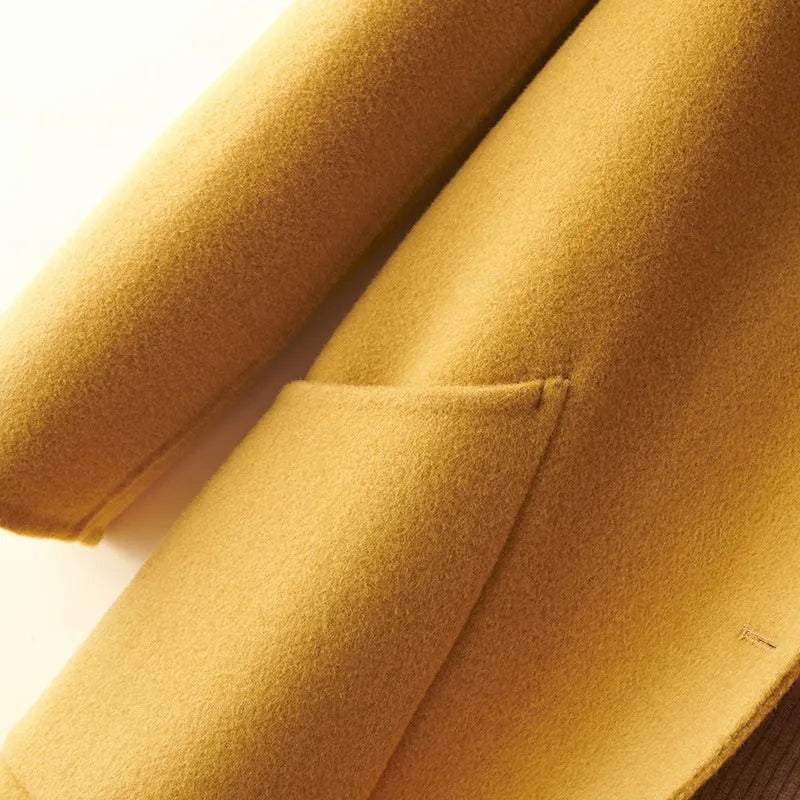 Women's double-faced wool mid-length coat with a doll collar and pearl buckle detail in a solid colour.