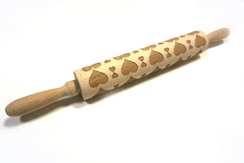 Festive rolling pin with embossed Christmas designs for easy imprinting on dough