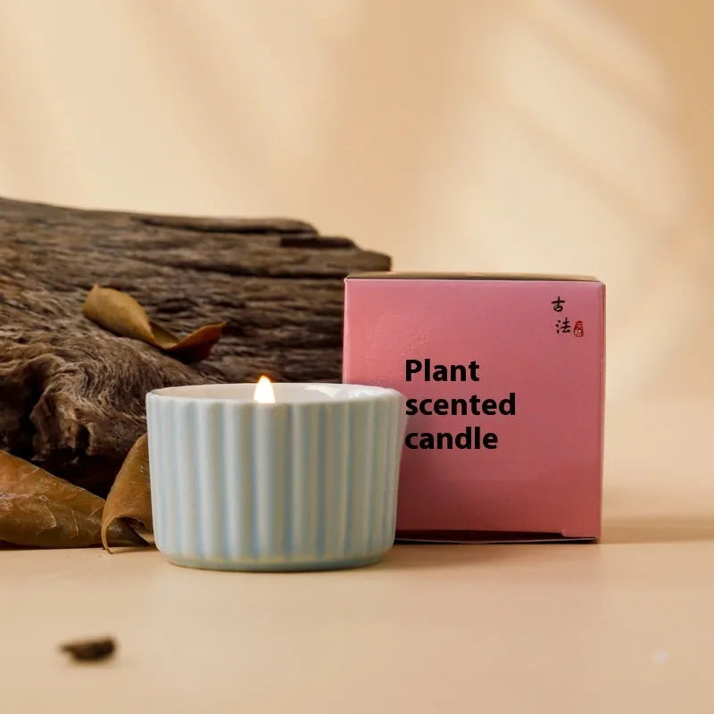 Soy wax aromatherapy candle inside a handmade ceramic cup, shown in a mint green colour.