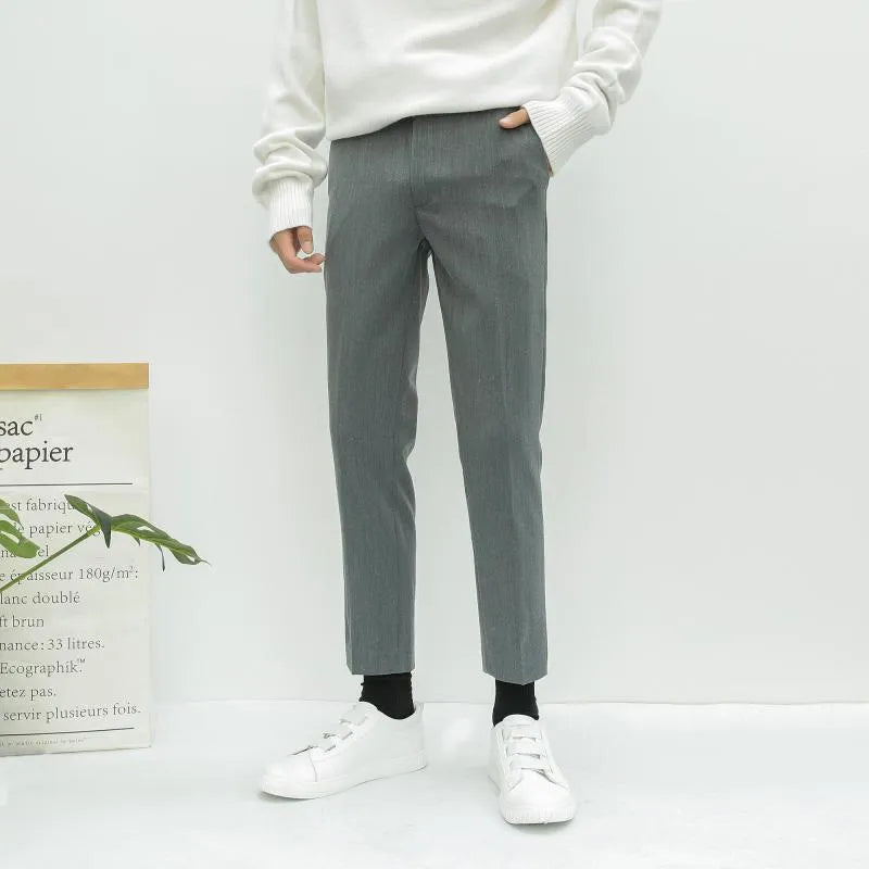 Man wearing black slim straight-leg loose fit cotton trousers with a drawstring waist