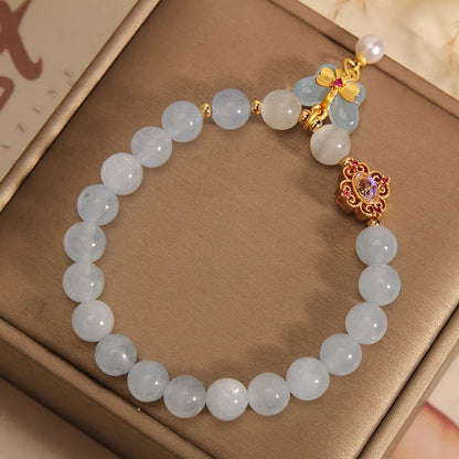 Women's crystal bracelet with a blue aquamarine butterfly pendant and rhinestone details.