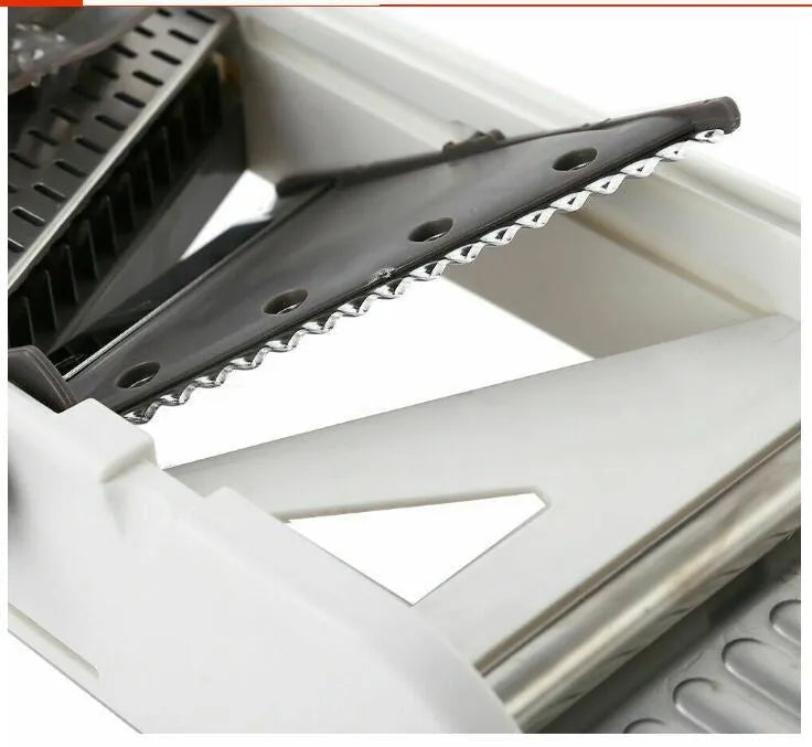 White kitchen vegetable slicer with stainless steel blades and adjustable thickness settings