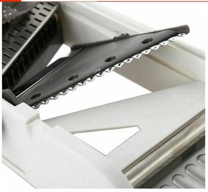 White kitchen vegetable slicer with stainless steel blades and adjustable thickness settings