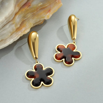 Women's tortoiseshell resin style earrings with 18K gold electroplated finish on stainless steel, heart and floral designs