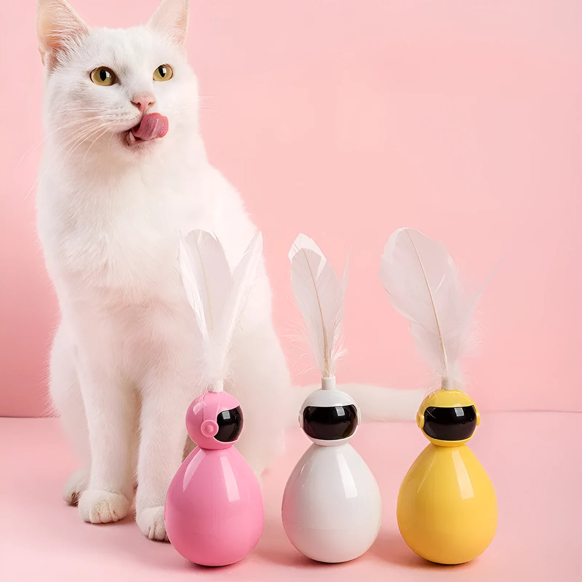 Tumbler cat toy in white, yellow, or pink with ABS body and feather replacement pieces.