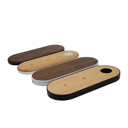 Ultra-thin bamboo and wood wireless charging stand for smartphones on a desk.