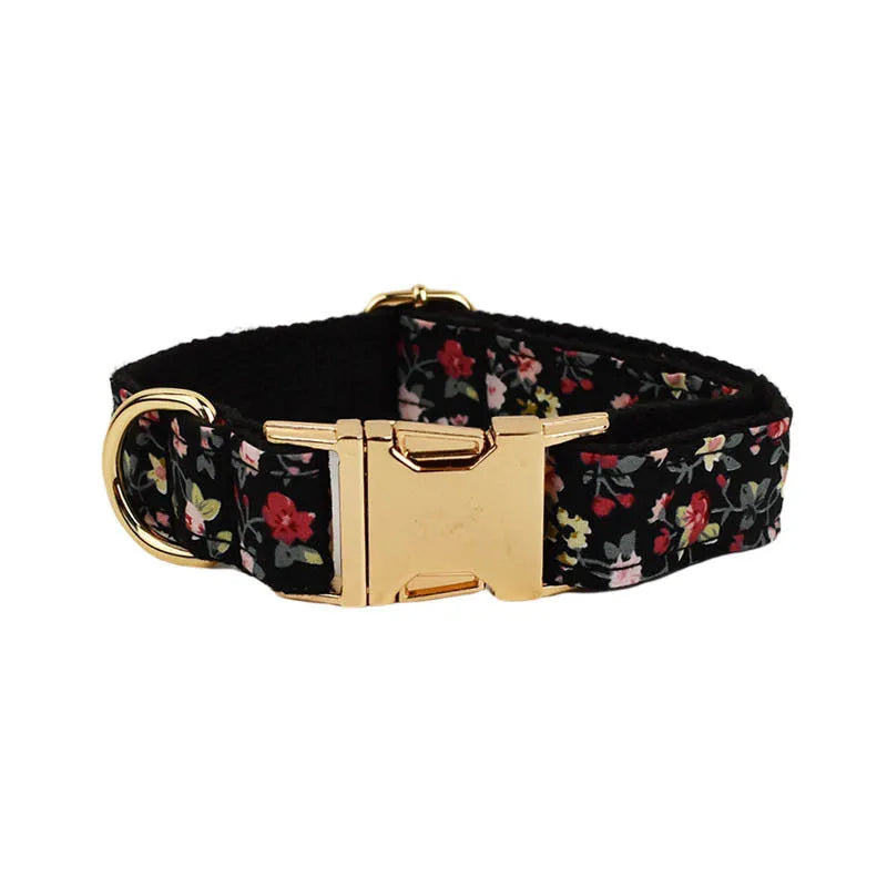 Four-piece dog accessory set showing a cloth collar, leash, vest, and removable bow with printed lettering.