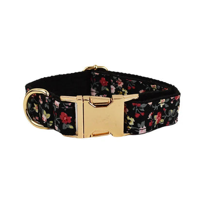 Four-piece dog accessory set showing a cloth collar, leash, vest, and removable bow with printed lettering.