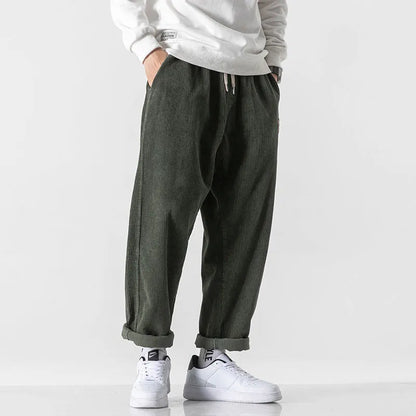 Men's loose fit corduroy sports trousers in Army Green colour with straight leg design and elasticated waist