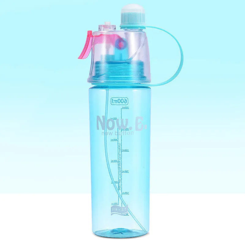 Green mist spray sports water bottle with handle, scale, and press-top lid on a gym bench.