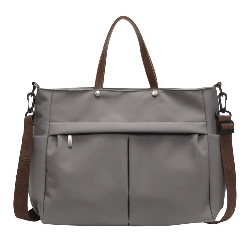 Nylon crossbody bag in five colours with 39x14x28cm dimensions and shoulder strap