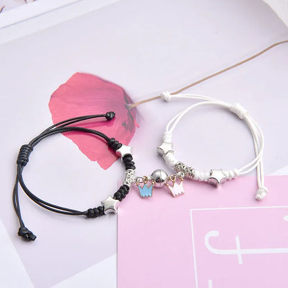 A pair of magnet couple bracelets with a suction clasp, showing various design options like clovers, crowns, and hearts.