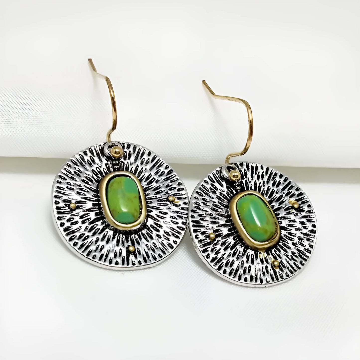 A pair of retro-style earrings with turquoise colour separation and an antique silver electroplated finish.