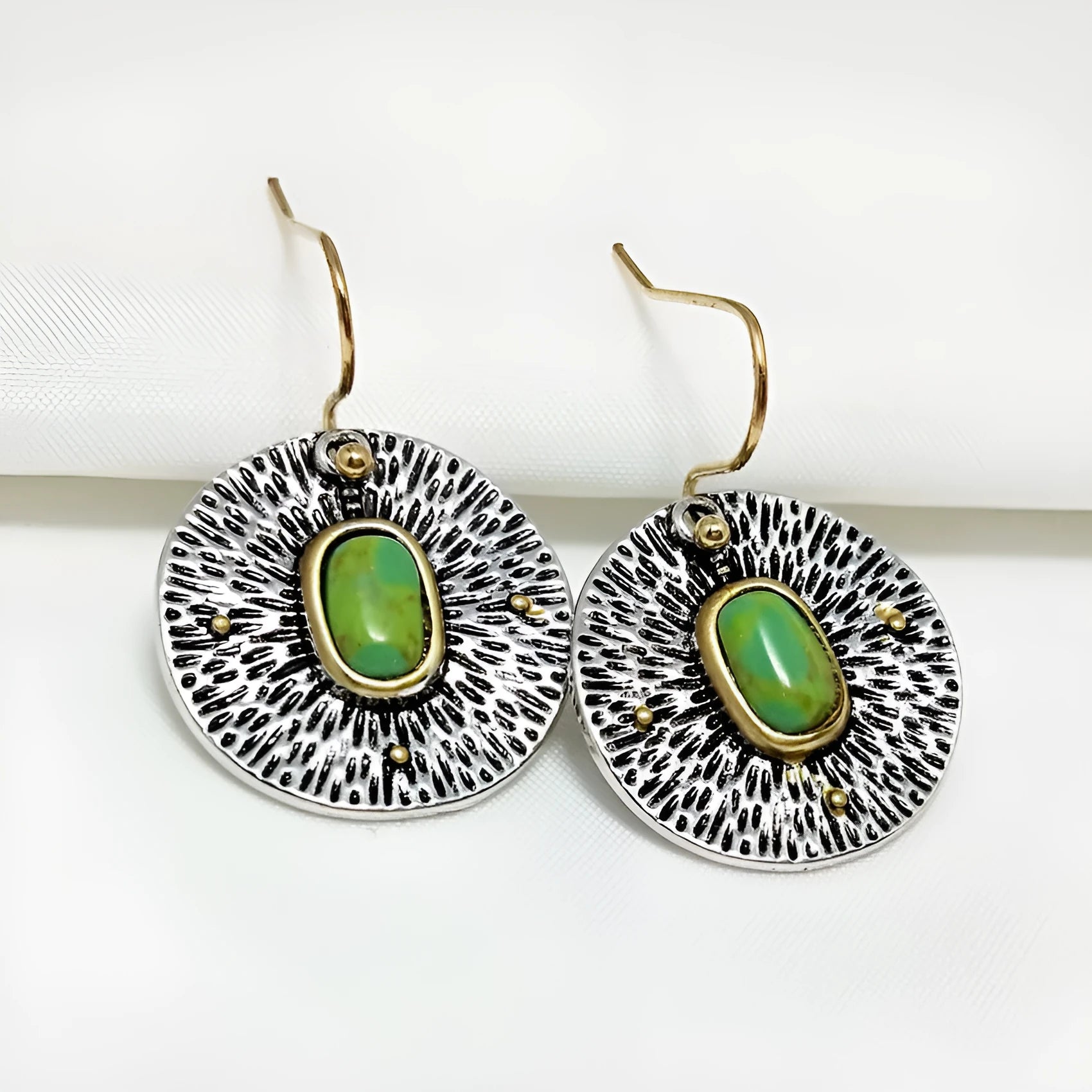 A pair of retro-style earrings with turquoise colour separation and an antique silver electroplated finish.