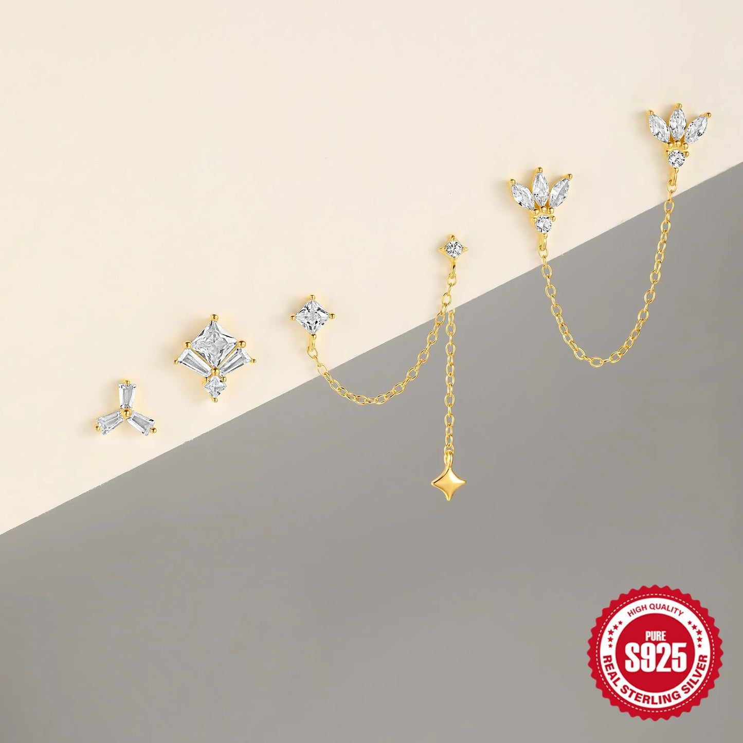 Close-up of a sterling silver double piercing chain stud earring with inlaid zircon stone in a golden colour.