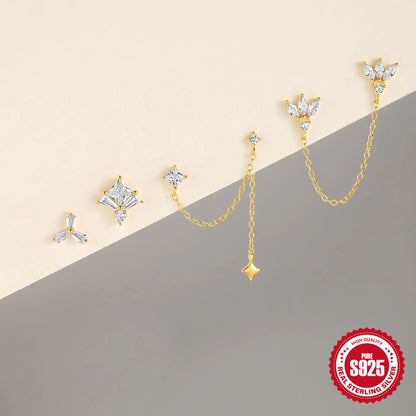 Close-up of golden-toned sterling silver double stud earrings with a delicate chain and sparkling zircon stone.