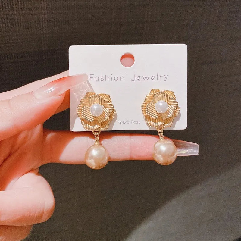 Gold-coloured floral stud earrings with a needle rose design, opal stone, and ice flower details.