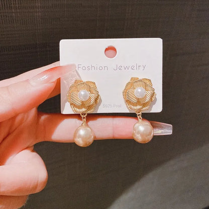 Gold-coloured floral stud earrings with a needle rose design, opal stone, and ice flower details.