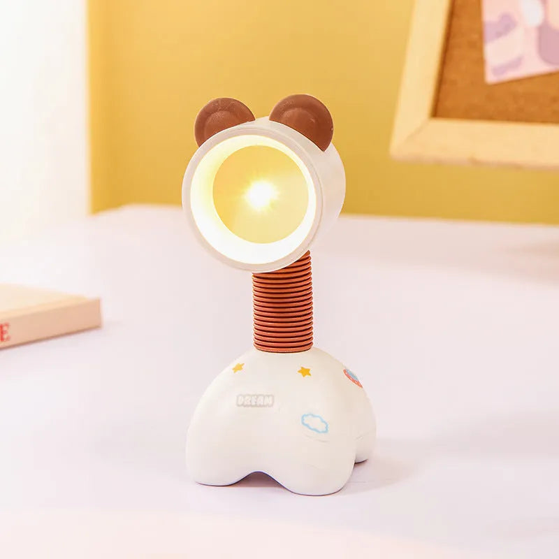 Colourful cartoon character magnetic DIY night light on a desk with adjustable head.