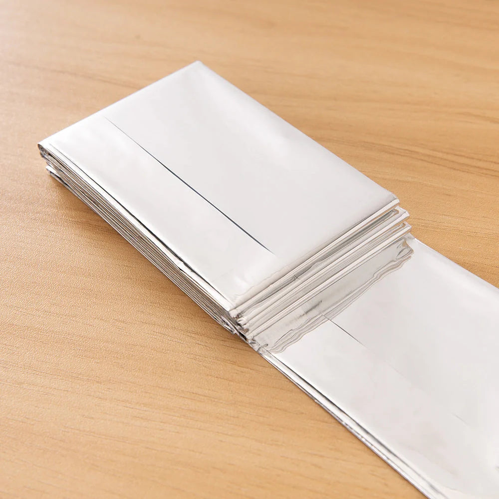Portable double-sided silver emergency thermal blanket for outdoor adventures and survival situations