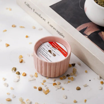 Soy wax aromatherapy candle inside a handmade ceramic cup, shown in a mint green colour.